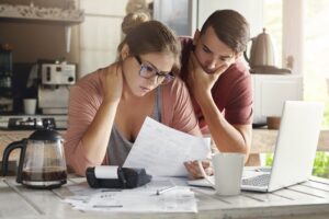young couple stressed because they owe taxes to the IRS